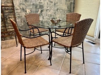 ROUND GLASS TOP DINING TABLE WITH BLACK IRON BASE & FOUR IRON & WICKER CHAIRS - LIGHT WEAR -TABLE: 42' W, 29'H