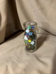 Glass Marbles In A Glass Milk Bottle