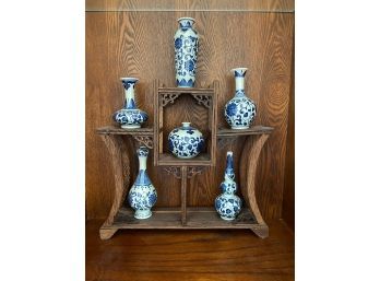 Collection Of Coordinating Blue And White Vases With Intricately Carved Display Shelf