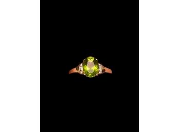 Oval Peridot In 10K Yellow Gold Setting With Three Diamonds On Each Side