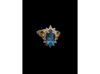 Marquis Cut Blue Topaz In 14 Karat Gold Surrounded By Diamonds