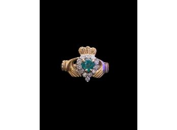Heart Shaped Emerald Surrounded By Diamonds In A 14 Karat Gold Claddagh Ring