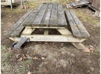 A Frame Picnic Table With Attached Benches And Casters On One Side