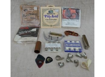 Assortment Of Guitar Strings And Picks