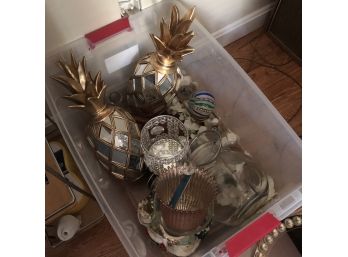 Assorted Decorative Items In A Bin With Pineapples