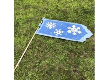 Snowflake Flag On A Wooden Pole