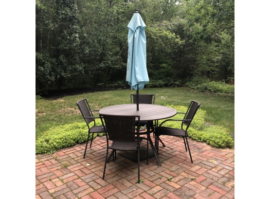 Patio Table With Fours Chairs And An Umbrella