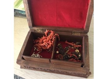 Costume Jewelry In A Box With A Floral Motif