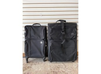Two Black Rolling Suitcases