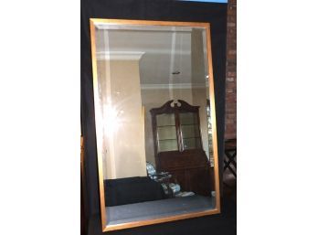 Heavy Wall Mirror With A Beveled Edge Encased In A Gold Painted Frame