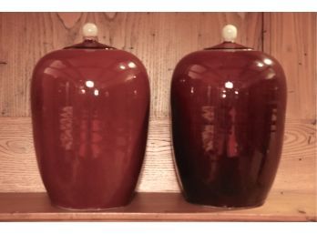 Pair Of Lidded Oxblood Tone Vases Measuring 12 Inch Tall By 8 Inches Wide.