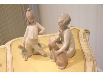 Lladro Hushing Dog Statue & A Statue Of A Little Girl With A Doll