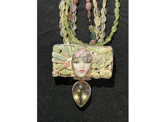 Romantic Eros Sterling  Pendant With Embelishments On Beaded Glass Chains. Background Is Frog And Firefly