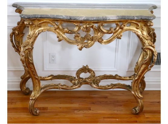 Exquisite Gilded Chavignol Rococco Console With A Thick Grey Marble Stone Top That Has A Beveled Ogee Edge