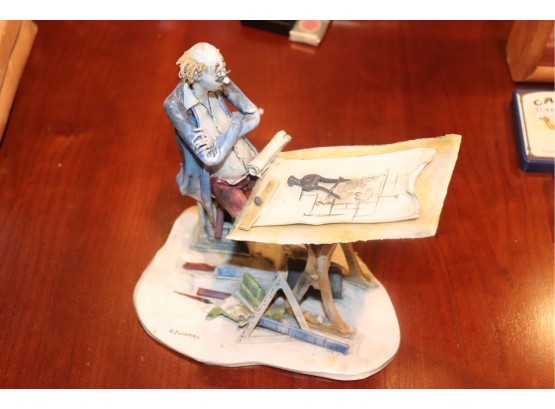 Whimsical Italian Porcelain Figurine Of Man Sitting At Drafting Table By Italinan Artist Colombo