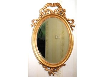 Gilded Oval Beveled Wall Mirror With Gold Ribbon Crest