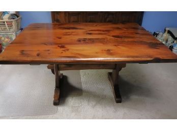 Early American Style Drop Leaf Trestle Table. The Table Has A Pinewood Top And Is Playing Style With Matt