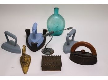 Antique Metal Irons, Includes A Vintage Brass U.S Mail Boxes, Sea Green Bottle, Iron Stand With New York P