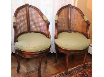 Pair Of Vintage Swivel Wood Chairs With A Cane Backrest & Padded Arm Rest