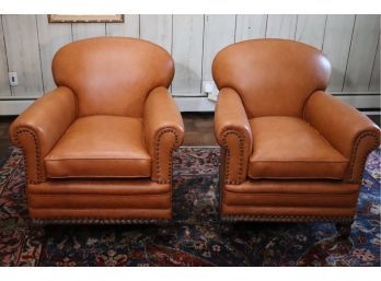 Pair Of Vintage Club Chairs Reupholstered In Leather With Nail Head Accents On A Carved Wood Frame On Casters