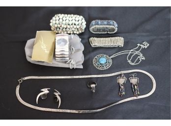 Women's Jewelry Lot Includes Gottex Watch, Long Silvertone Chain, Skull Ring & Flex Bracelets