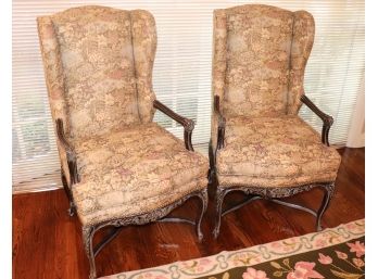 Pair Of Custom Floral Brocade Arm Chairs With Carved Detail And Studding Along The Bottom