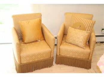 Pair Of Small Gold Club Chairs With Gold Fringe Bottom And Decorative Pillows