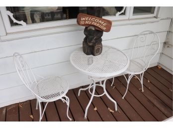 White Wrought Iron Bistro Set With Carved Bear Holding Welcome Sign