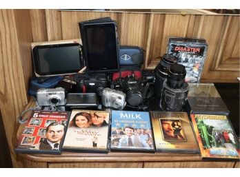 Mixed Lot Of Assorted Cameras, Handheld Devices, And DVDs, As Is Condition