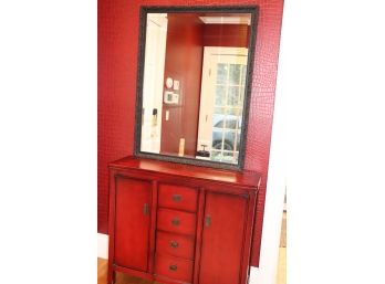 Small Red Cabinet With Center Drawers And Black Beveled Edge Wall Mirror With Foliage Detailed Frame