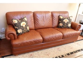Cognac Colored Leather Roll Arm 3 Seat Sofa With 2 Coordinating Patterned Throw Pillows
