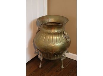 DECORATIVE OVERSIZED BRASS URN WITH GRIFFIN DESIGNED LEGS AND NORTHWINDS DETAIL ON HANDLES
