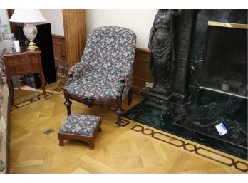 ANTIQUE CURVED BACK ARMCHAIR ON WOODEN LEGS WITH CASTERS AND TAPESTRY UPHOLSTERY & SMALL FOOT STOOL