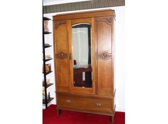 ANTIQUE OAK MIRRORED ARMIORE WITH CARVED DETAIL AND BOTTOM DRAWER FOR STORAGE