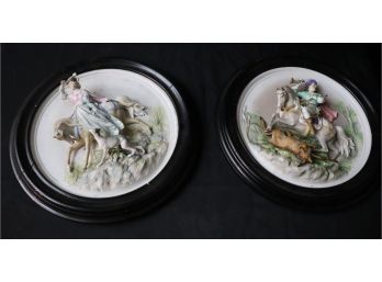 Pair Of Bisque Porcelain Wall Plaques Featuring Hunting Scenes And Having Round Wood Frames