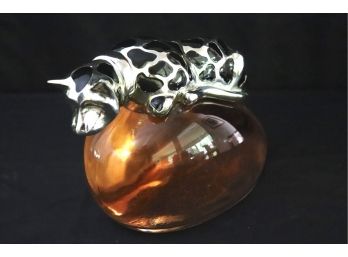 Unique Statement Piece Chrome Dog With Black Spots Sitting On Top Of A Pink Liquid Filled Oval Container