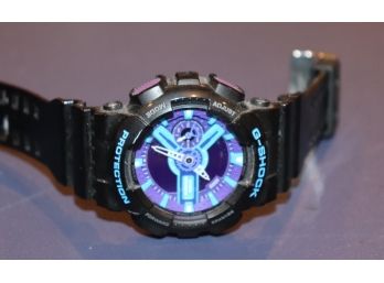 Black G Shock Watch With Blue And Purple Face From Casio 200 Meter Water Resistant