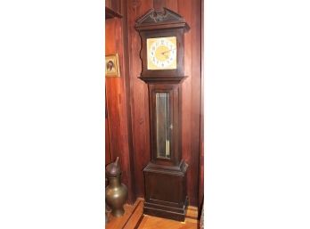 Classic Dark Wood Grandfather Clock With Ornate Metal Face