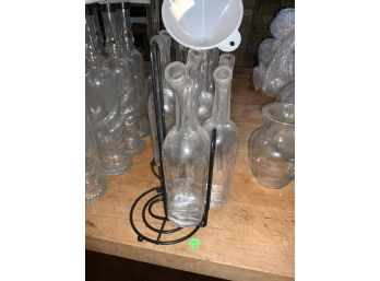 Lot Of Oil And Vinegar Glass Containers Sitting In Metal Paper Towel Holders