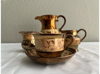 Five Lusterware Pitchers Creamers And Cup And Saucer