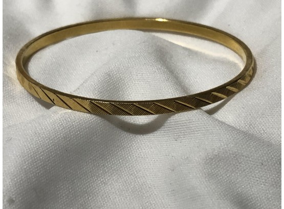 Monet Signed Continuous Gold Tone Metal Bangle With Diagonal Line Design