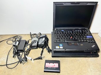 Lenovo Thinkpad Laptop With Attached Battery And Charging Chords
