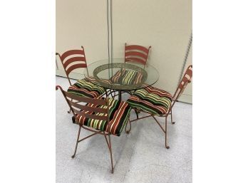 Four Heavy Wrought Iron Outdoor Chairs With Glass Top Table