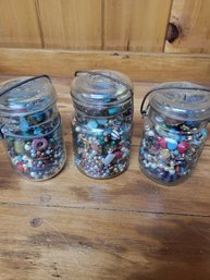 Three Jars Full Of Different Beads For Making Jewelry