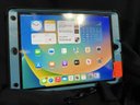 IPad 8th Generation, Software 14.2, M: A2428; 32GB, Screen Protector, Black/Blue Otter Box Case With Kick Stand; Cleaned To Original Factory Settings, Home Button, Battery Does Charge But No Charger Included