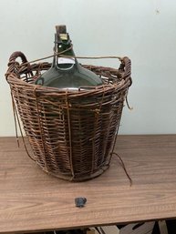 Green Glass Bottle In Basket Wit Shipping Straw & Rope, Approx 27' Tall