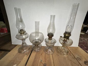 4 Kerosene Lamps, Clear Glass, One With Etched Shade, All Others With Chimneys