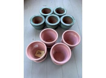 Lot Of (4) Mini Pink Glazed Clay Pots With Attached Bases; (5) Green Glazed Clay Pots With Unglazed Bottoms Sitting In Bases