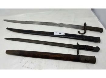 Lot Of 2 Bayonetts With Scabbard 1913 Remington Wooden Handle 21' Long, (1) Stamp P W/ Brass Handle 26' Long