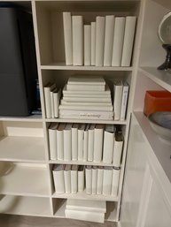 Collection Of Hardcover Books, Covered With White Paper For Staging